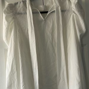 White puffed sleeved collarless shirt with neck ties.